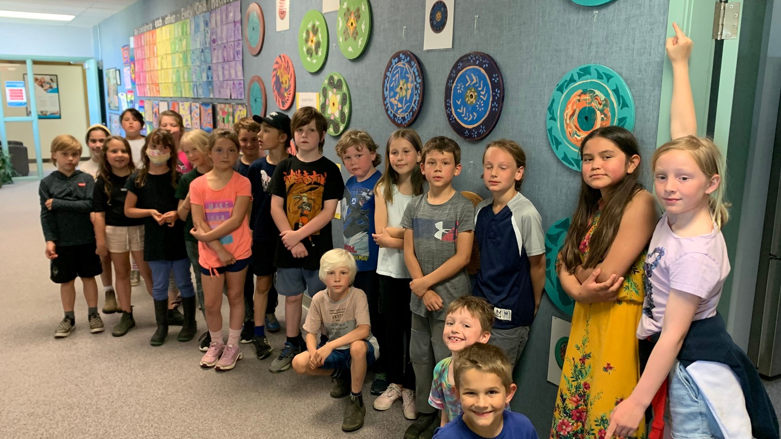 Ms. Coulter's grade 2/3 class in front of their Spindle Whorl project.