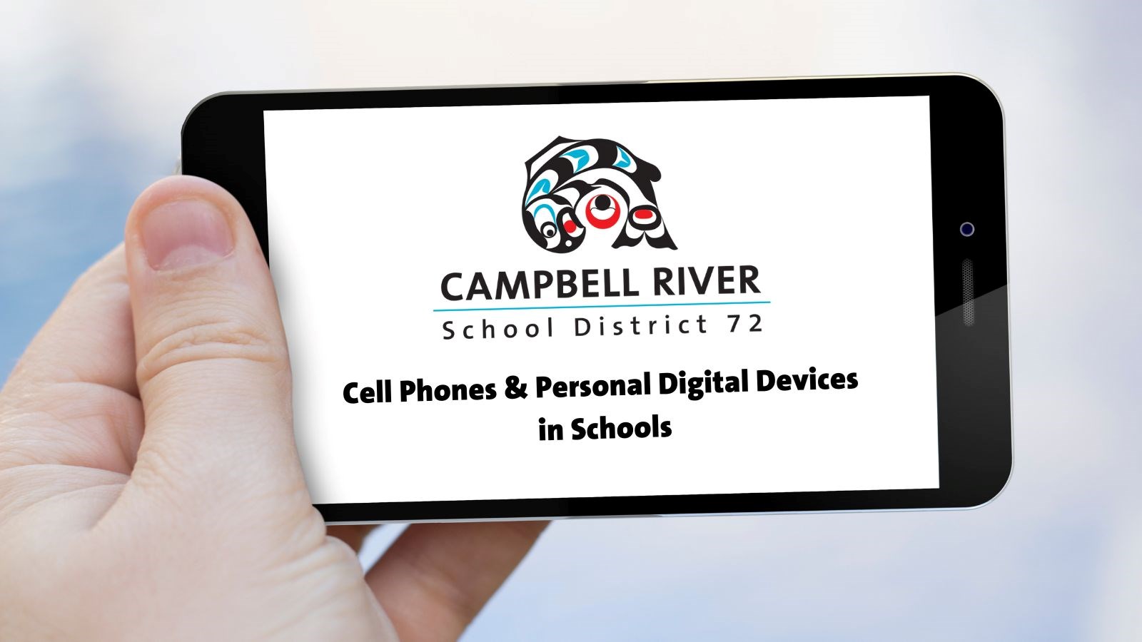 A hand holding a cell phone that has the district logo and the words "cell phones and personal digital devices in schools" on the screen.