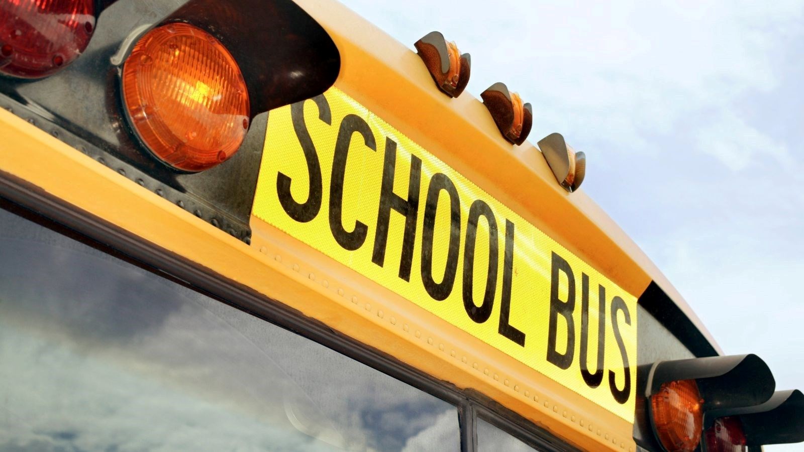 Photo of the top, front of a yellow school bus.