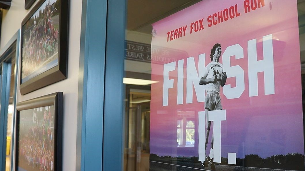 Terry Fox poster hanging in the entrance of a school.