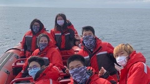 International students in zodiak on whale watching trip.